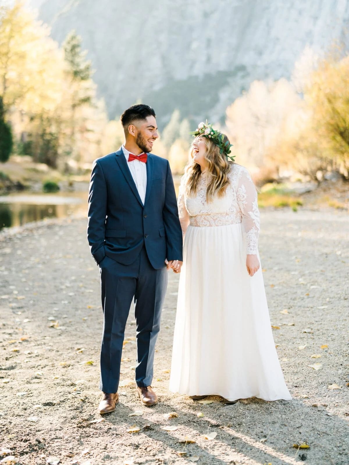 A couple in wedding attire holding hands during a Yosemite elopement.